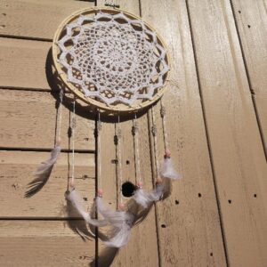 Handmade Crochet Round Wall Decoration With Feathers view from the bottom